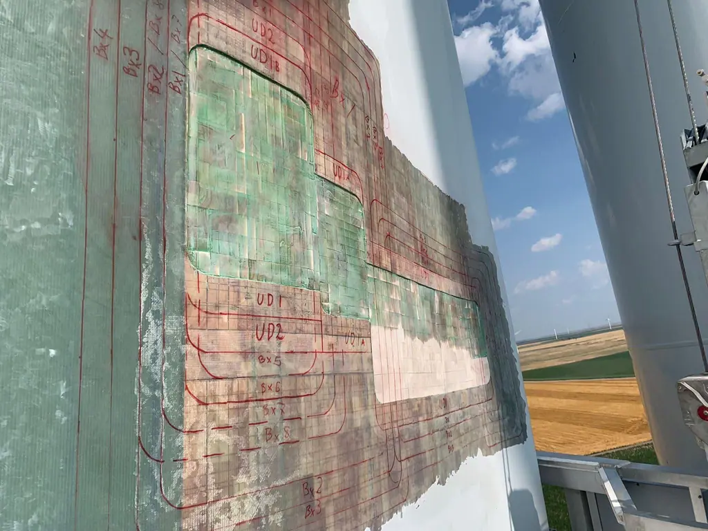 Wind turbine blade repair with the balsa core installed and the laminate ply layers marked up in red